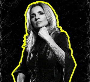 Miss Djax in a black-and-white portrait, raising one arm with a yellow silhouette outline.