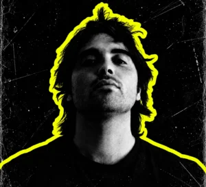 Regis in a black-and-white portrait against a dark background with a yellow cutout outline.